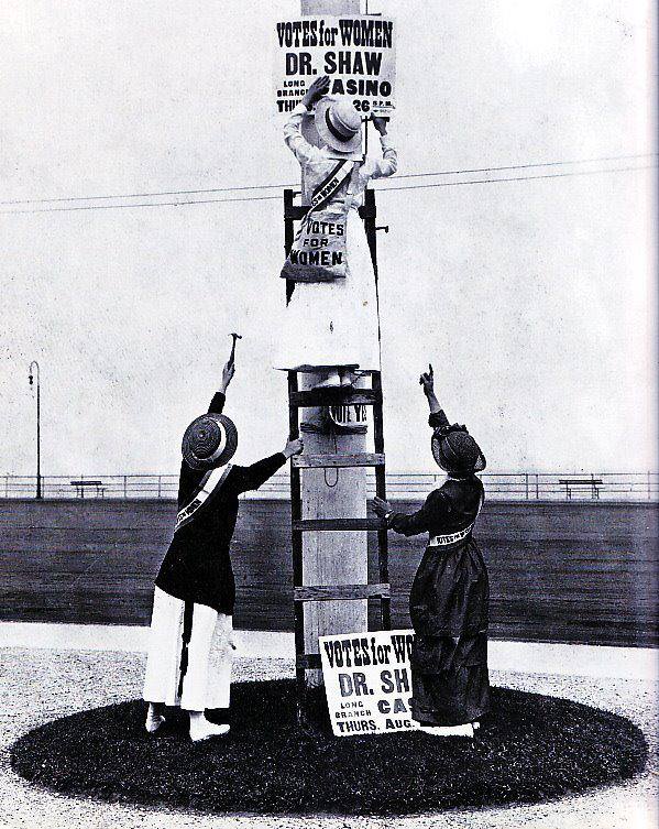 Suffrage workers putting up signs in Asbury Park earlier this year, advertising Dr. Anna Howard Shaw's speech to a meeting of the New Jersey Woman Suffrage Association at the Long Branch Casino on August 26th.